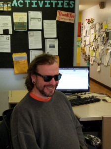 Male volunteer sitting at front desk Volunteer at front desk