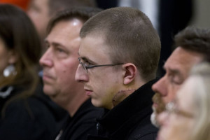 Micah Fletcher sits watching Jeremy Christian in court