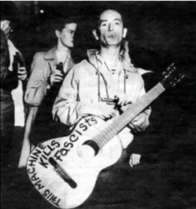 Woody Guthrie, This Machine Kills Fascists written on body of his guitar Photo by Karen Apricot, Woody Guthrie, This Machine Kills Fascists written on body of his guitar