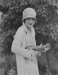 1920s Image of a woman holding a traditional bowlback mandolin