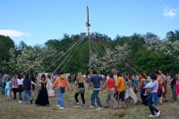 People dancing around the May Pole