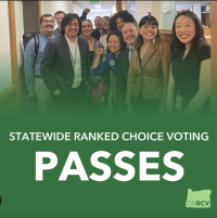 Blair Bobier of Oregon Ranked Choice Voting Oregon Ranked Choice Voting staff poses in hallway smiling