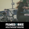 image of girl on motorcycle with bmx bike strapped to back
